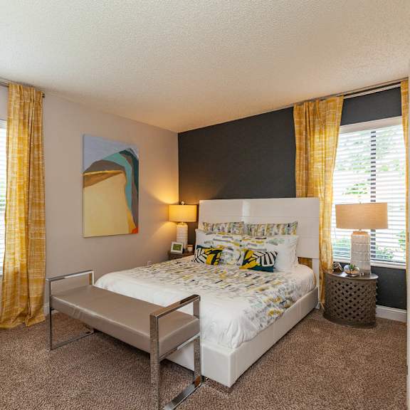 bedroom with expansive windows at the reserve at barry apartments, kansas city, missouri