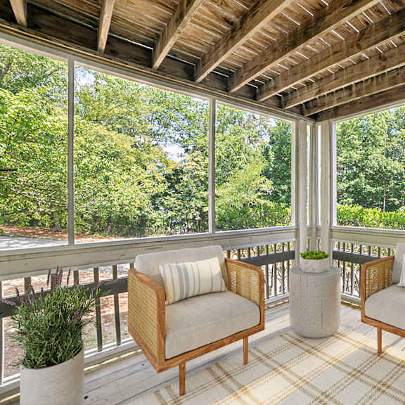 a wooden balcony with two chairs and a table at beacon ridge apartments, prg real estate management, greenville, 29615