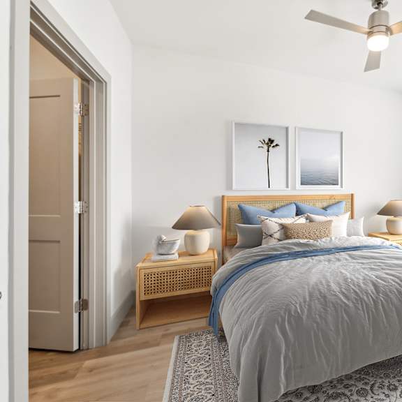a bedroom with a bed, two lamps, and a ceiling fan at the point apartments on 38th, norfolk, virginia