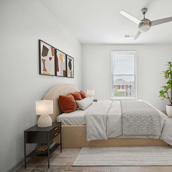 a bedroom with a bed, a ceiling fan, and a television at circ apartments, virginia
