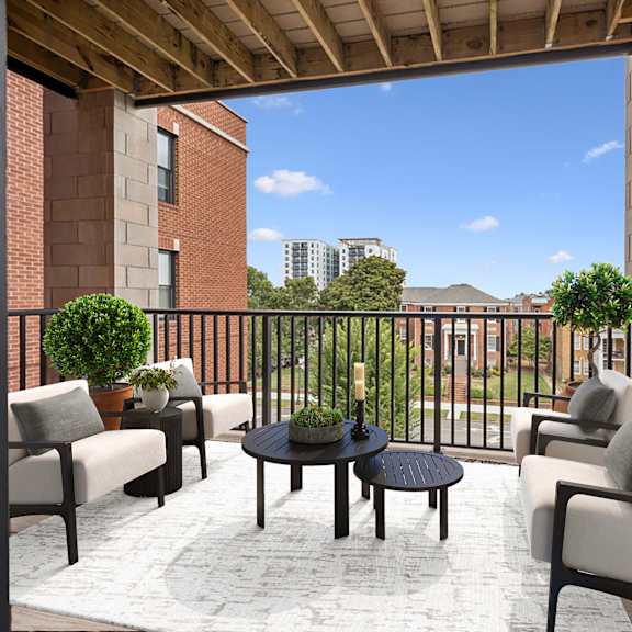 a patio with a table and chairs overlooking a city at circ apartments, virginia