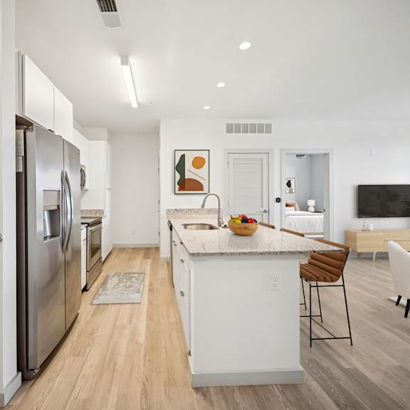 a modern kitchen with white appliances and a wooden floor at circ apartments, virginia
