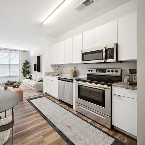 a modern kitchen with a dining table and chairs at circ apartments, virginia