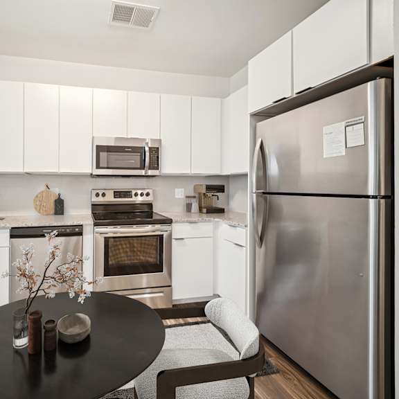 a modern kitchen with a refrigerator, oven, and microwave at circ apartments, virginia