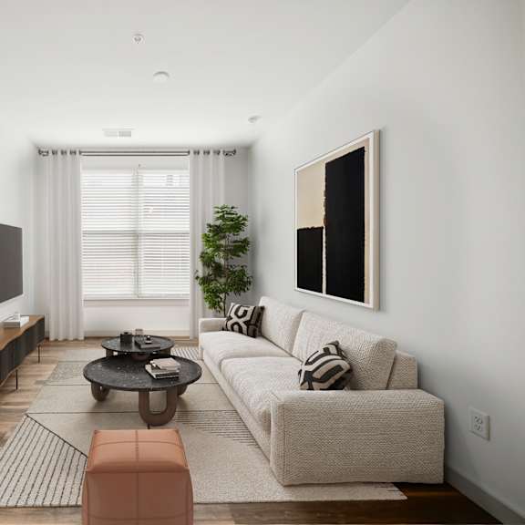 a modern living room with a large couch, a flat screen tv, and a coffee table at circ apartments, virginia