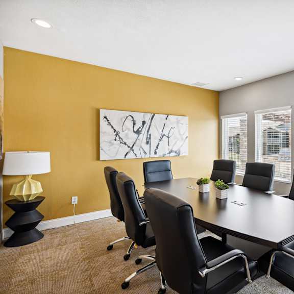 a conference room with a large table and chairs at the reserve at barry apartments, kansas city, missouri