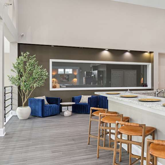 a modern kitchen with a bar area and seating.