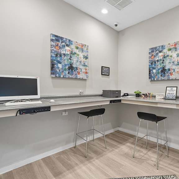 a room with two computers and two chairs.