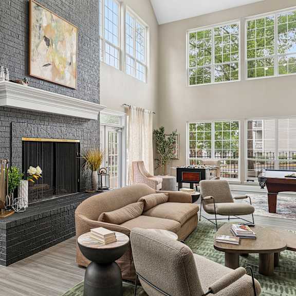 a living room with a fireplace and a pool table.