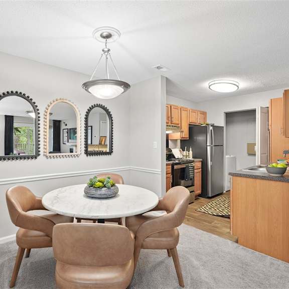 a dining room with a table and chairs.