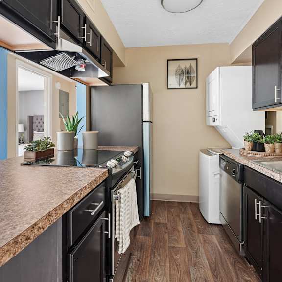 kitchen area with washer and dryer at the grove at lyndon apartments louisville ky