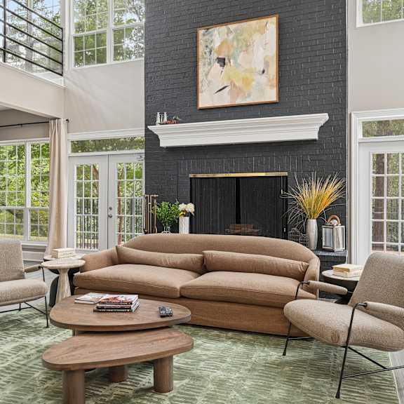 a living room with a fireplace and a painting above it.