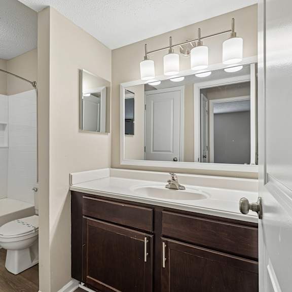 a bathroom with a white sink and a toilet.