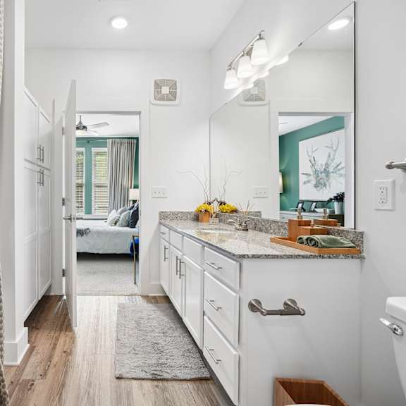 a bathroom with a white tub and a white sink.