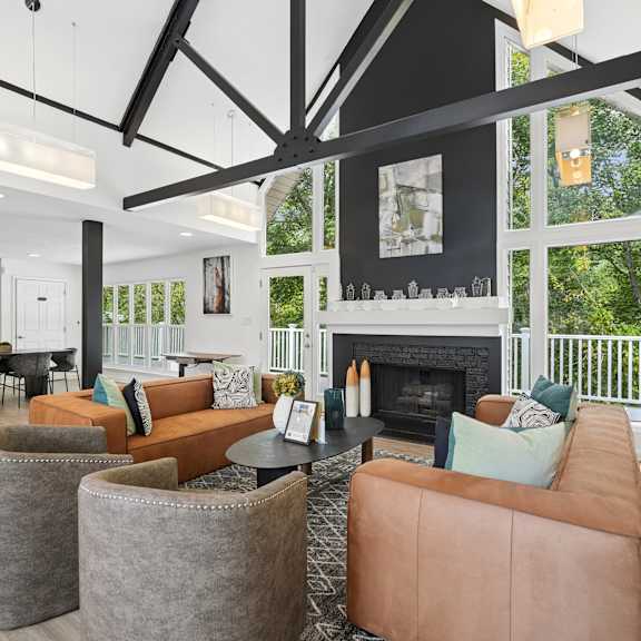 community clubhouse lounge with fireplace and balcony access at park ridge estates