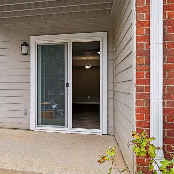a white door with a glass window is on the side of a house.