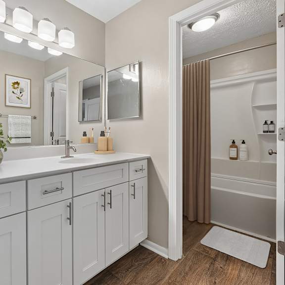 a bathroom with a vanity and a mirror.