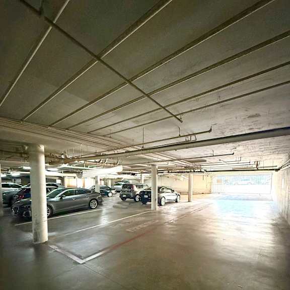 a parking garage with cars parked in it.