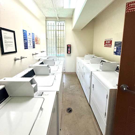 a laundry room with washers and dryers.