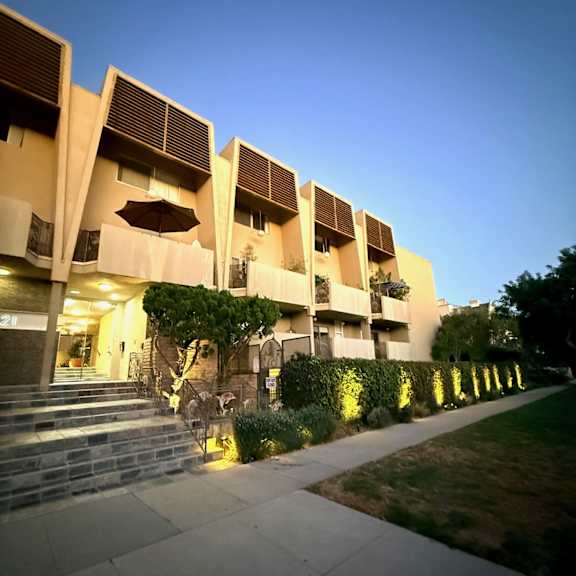 a building with a unique design is shown at dusk.