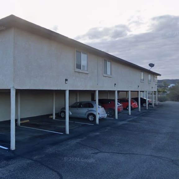 a parking lot with a building and cars parked.