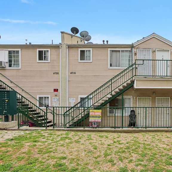 apartment complex with a green lawn in front.