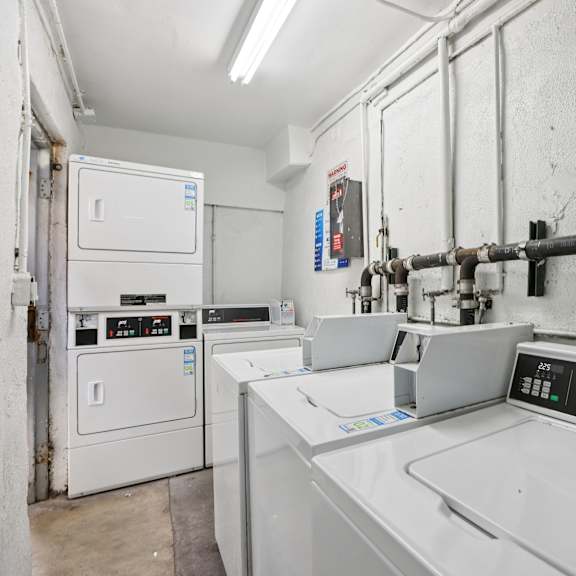 a machine shop with a white floor and walls, and a variety of machines and tools.