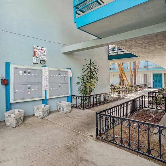 a blue wall with a white electrical panel and a sign on it.