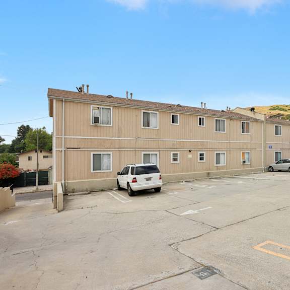 a parking lot with a building in the background.