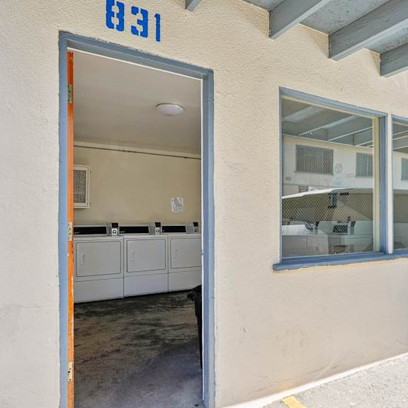 a white building with a blue number 831 on the wall.