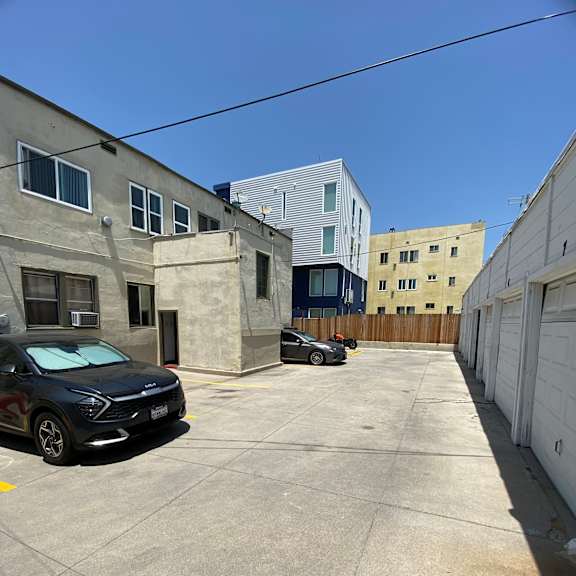 a black car is parked in a concrete lot.