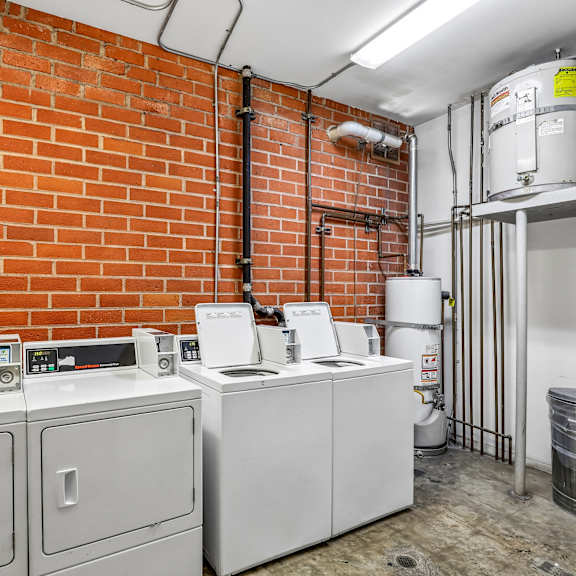 a room with a red brick wall and a white tank.