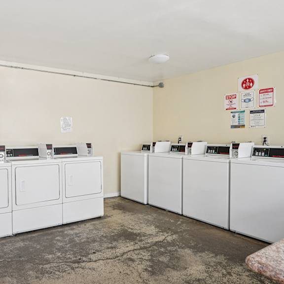 a row of washing machines in a laundromat.