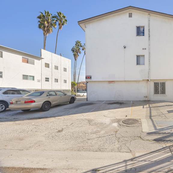 a white building with a gate in front of it.