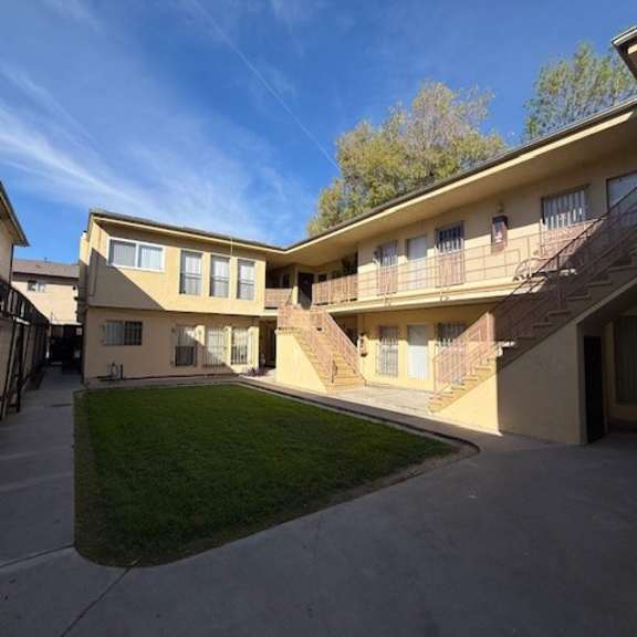 a sunny day at a residential complex with a clear blue sky.