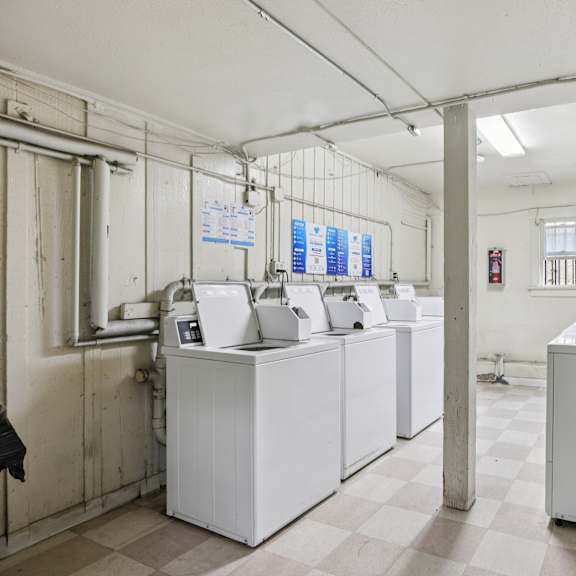 a room with white appliances and pipes.