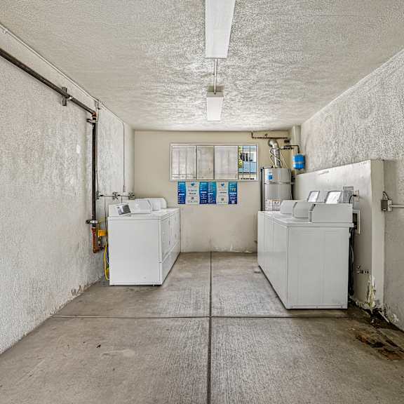 a clean, empty industrial space with white walls and a concrete floor.