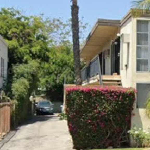 a house numbered 423 is surrounded by greenery.