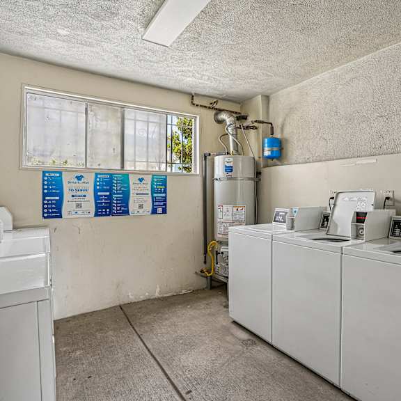 a laundry room with washers and dryers.