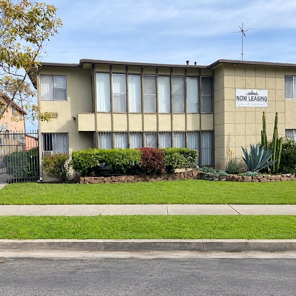 a building with a sign that says "now leasing" on it.