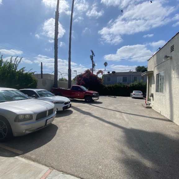 a silver dodge charger is parked in a driveway.