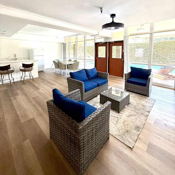 a living room with a blue couch and a glass door.