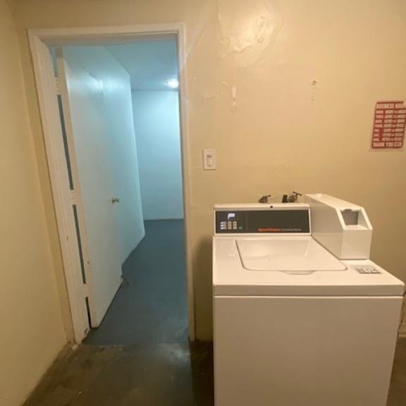 a white washing machine in a small room.