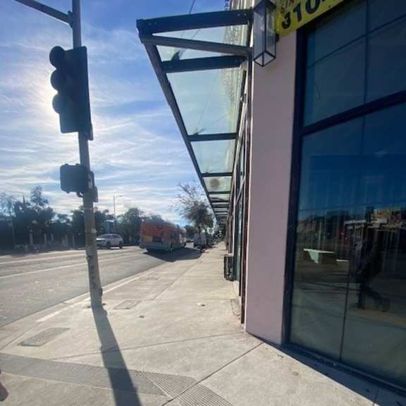 a traffic light on a pole at a street corner.