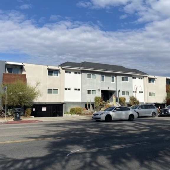 a modern building with a parking lot in front.