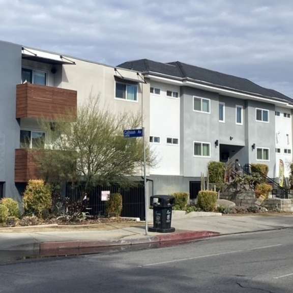a modern apartment building with the number 14158 on its facade.