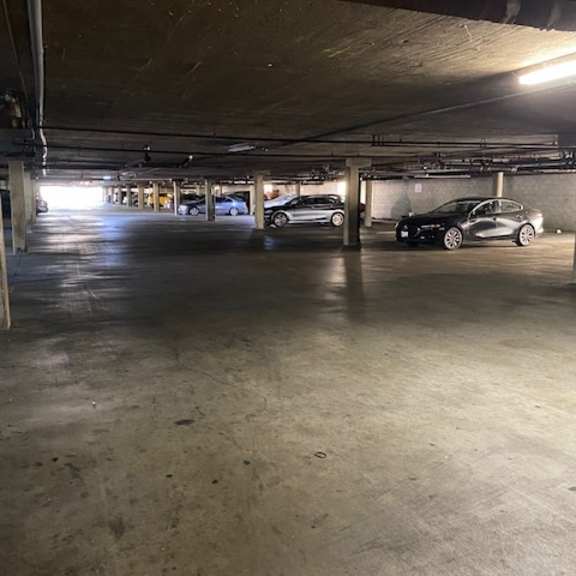 a parking garage with a few cars parked in it.