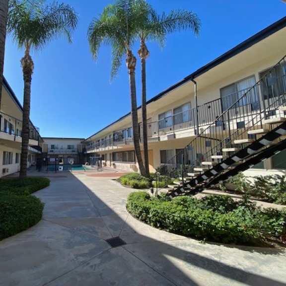 a sunny day at the apartment complex with a clear blue sky.