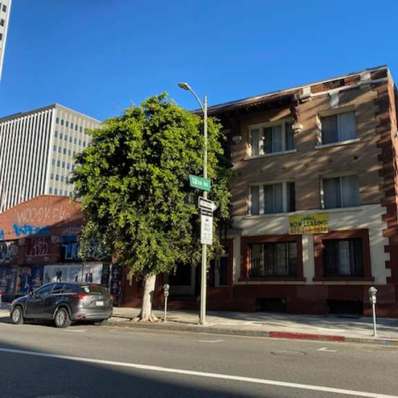 a building with a sign that says "now hiring" on the front.