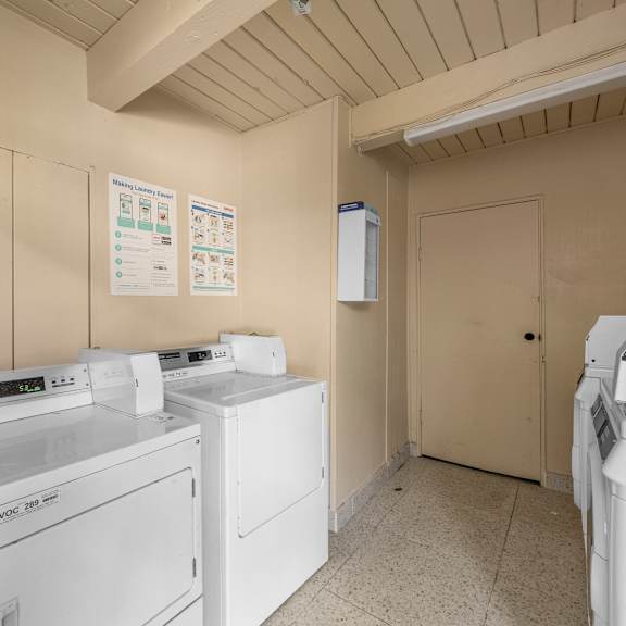 a laundry room with washers and dryers.